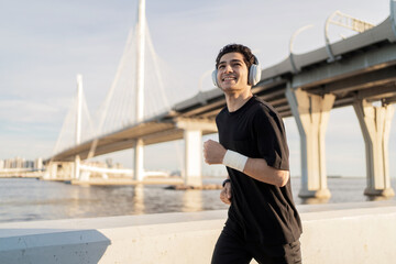 A runner trains active fast running in the city with headphones.