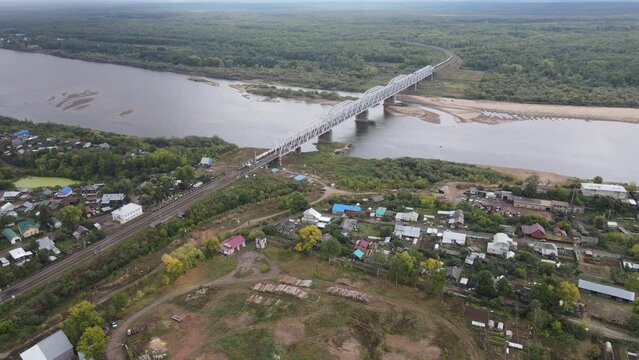 Bridge in small settlement on river shore