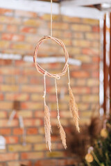 dream catcher on the background of a brick wall, close-up