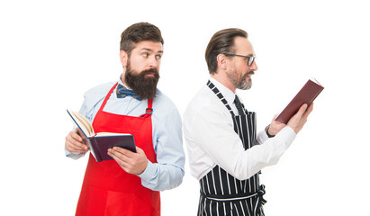 in search of better recipe. cafe and restaurant opening. bearded men with recipe book. menu planning. chef team in apron. catering business. seating plan. partners cook cooking. Culinary ingredient