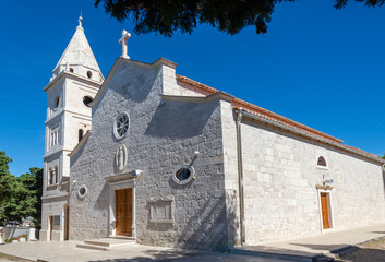 St. George's Church made of white limestone standing atop a mountain on the island. Primosten,...