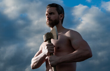 shirtless man with axe. caucasian man hold hatchet. brutal man on sky background