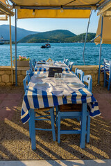 Reserved table in Greek tavern in Vathy in the picturesque port of Vathy village, the capital of Ithaca island, Ionian, Greece.