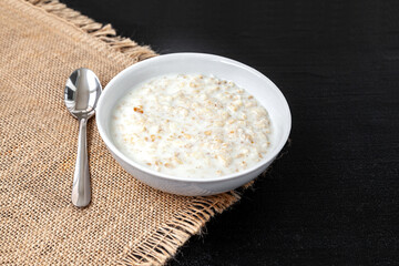 Plate with oatmeal - dark background