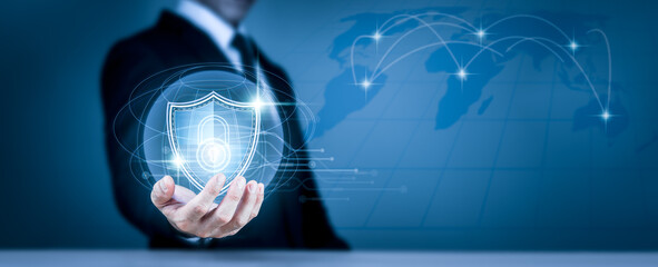 A businessman holds a shield protect symbol, which might be for an internet firewall, insurance, or...