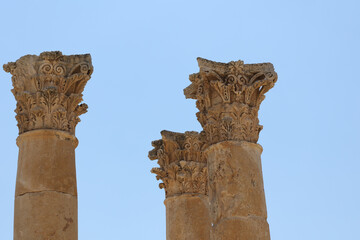 close view of greco-roman capitals against blue sky