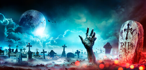Fototapeta Zombie Hand Rising Out Of A Graveyard At Night With Full Moon obraz