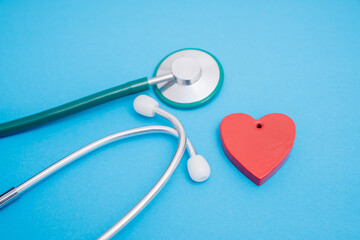 medical stethoscope and red heart on a blue background