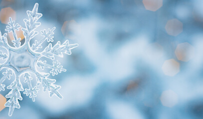 Winter snow background abstract bokeh. Snowflake Close-Up. Free space for text.