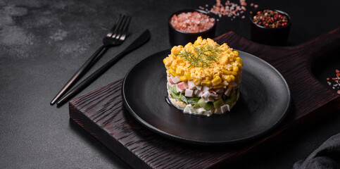 Fresh vegetable salad with corn, pepper, crab, cucumber, eggs and mayonnaise
