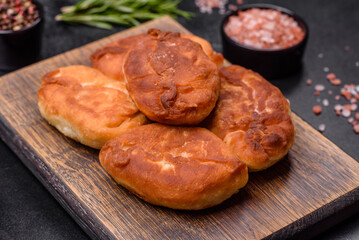 Cooking pies with potato on a wooden cutting board