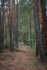 walking man in autumn forest