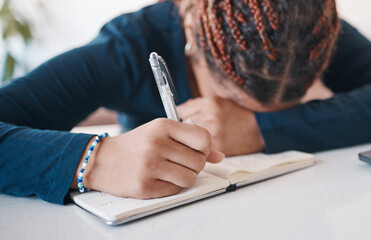 Hand, writing and notebook with an author or writing suffering from stress, anxiety or burnout in...
