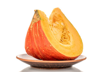 One piece of ripe organic pumpkin on earthenware, macro, isolated on white background.
