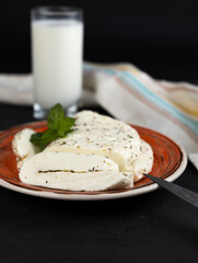 Homemade halloumi from goat milk with the addition of mesophilic sourdough. White Cheese for grilling. An organic dairy product from a local farm.