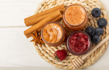 Jar of honey. Fruit honey with raspberries and blueberries.Useful fortified beekeeping product for health and beauty.Cream honey.Vegetarian diet organic product.Copy space. place for text