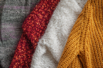 Autumn and winter background with knitted colourful sweaters