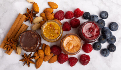 Jar of honey. Fruit honey with raspberries, blueberries, almonds and pistachios. Useful fortified beekeeping product for health and beauty. Honey cream. Vegetarian diet organic product. Copy space.