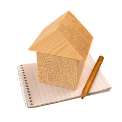 Home budget and plan concept. House of wooden blocks standing on a notebook with a pencil isolated...