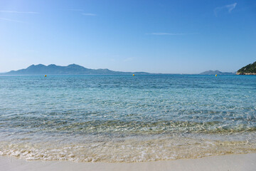 Fototapeta na wymiar Beautiful turquoise mediterranean waters with mountains around in spanish island 
