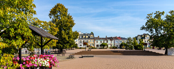 Historic quarter market square with tenement houses and waterworks in old town quarter of Tarnobrzeg in Poland