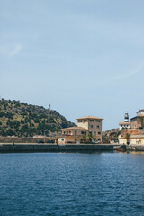 Fototapeta na wymiar Beautiful look at mediterranean seaport with two lighthouses at horizon 
