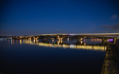 KIEV, UKRAINE - JANUARY 6, 2020: PARK BRIDGE (pedestrian bridge) ILLUMINATED BY NIGHT