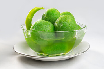 Chili sweets on bowl. green colored, chilli flavored, hot and sweet taste. unusual odd taste.