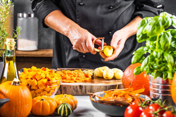 mid section of chef preparing fresh organic ingredients for pumpkin soup