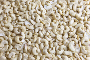Many cashews spread out on a table. Healthy and tasty snack. Cashew
