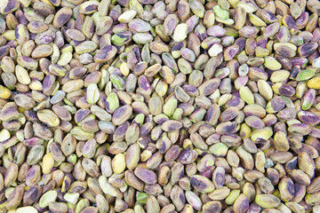 Many pistachio nuts spread out on a table. Healthy and tasty snack. Pistachios