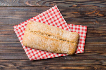 Fresh ciabatta bread on napkin on rustic background, Italian bread top view
