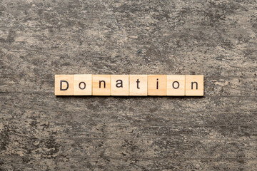 donation word written on wood block. donation text on table, concept