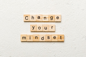 Change your mindset word written on wood block. Change your mindset text on cement table for your desing, Top view concept
