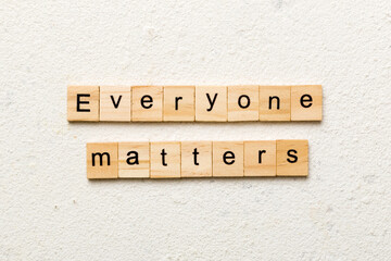 Everyone matters word written on wood block. Ever yone matterstext on cement table for your desing, Top view concept