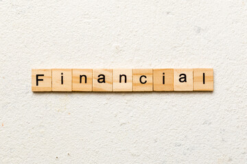 financial word written on wood block. financial text on table, concept