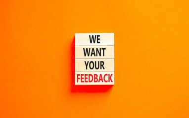 Support and we want your feedback symbol. Concept words We want your feedback on wooden blocks on a beautiful orange table orange background. Business, support we want your feedback concept.