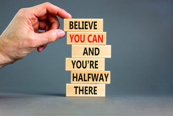 You can symbol. Concept words Believe you can and you are halfway there on wooden blocks on a beautiful grey table grey background. Businessman hand. Business motivational and you can concept. - obrazy, fototapety, plakaty