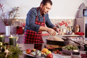 Man preparing delicious and healthy Christmas duck in home kitchen. - 531312342