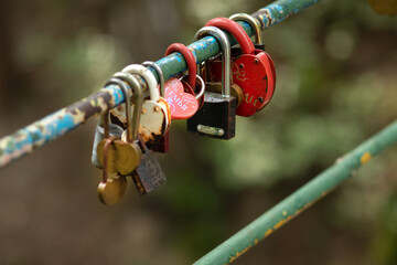 Tradition of love to hang a padlock on a bridge. Red heart lock