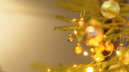 Obraz premium Christmas home room with Christmas tree and festive bokeh lighting, on background kitchen decorated for holiday . Christmas and new year interior-blurred background. Lots of lights that glow in dark.