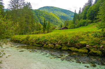 The Krumme Steyr river near the village Hinterstoder and famous lake Schiederweiher. Pure fresh water near Austrian Alps and mountains peaks. Soft colors, peace in nature.