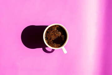 A cup of coffee on the lilac background