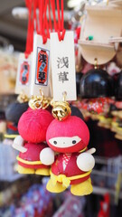 Closeup of Wooden Japanese Funny Red Ninja Doll Ring ang Blessing Tag Souvenirs at Asakusa street, Sensoji temple