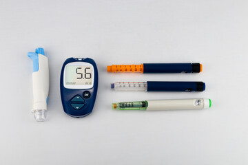 glucose meter, glucometer, syringe pen, scarifier on a white background