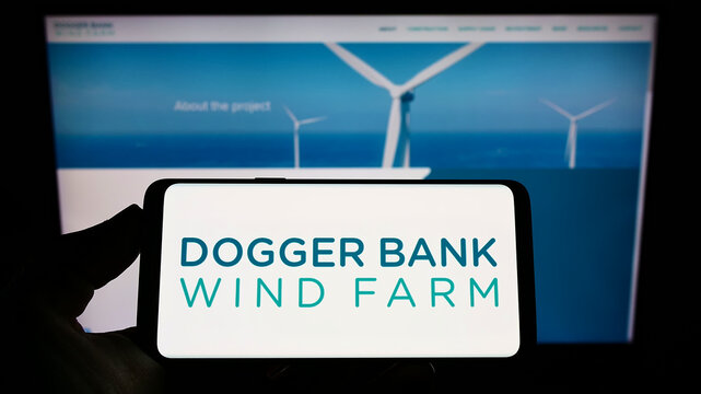 Stuttgart, Germany - 09-11-2022: Person Holding Smartphone With Logo Of Offshore Energy Generator Dogger Bank Wind Farm On Screen In Front Of Website. Focus On Phone Display.