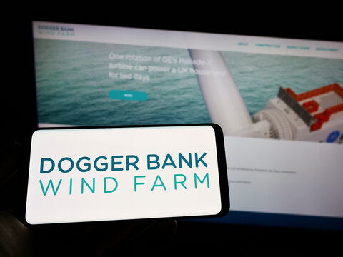 Stuttgart, Germany - 09-11-2022: Person Holding Cellphone With Logo Of Offshore Energy Generator Dogger Bank Wind Farm On Screen In Front Of Webpage. Focus On Phone Display.