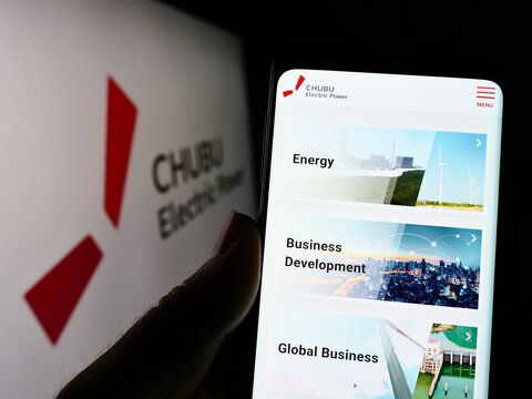 Stuttgart, Germany - 09-11-2022: Person holding smartphone with website of Japanese company Chubu Electric Power Co. Inc. on screen with logo. Focus on center of phone display.