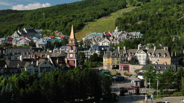 Aerial of Mont Tremblant ski resort and clock tower on beautiful summer day in Quebec, Canada