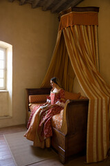 Renaissance lady on canopy bed - obrazy, fototapety, plakaty